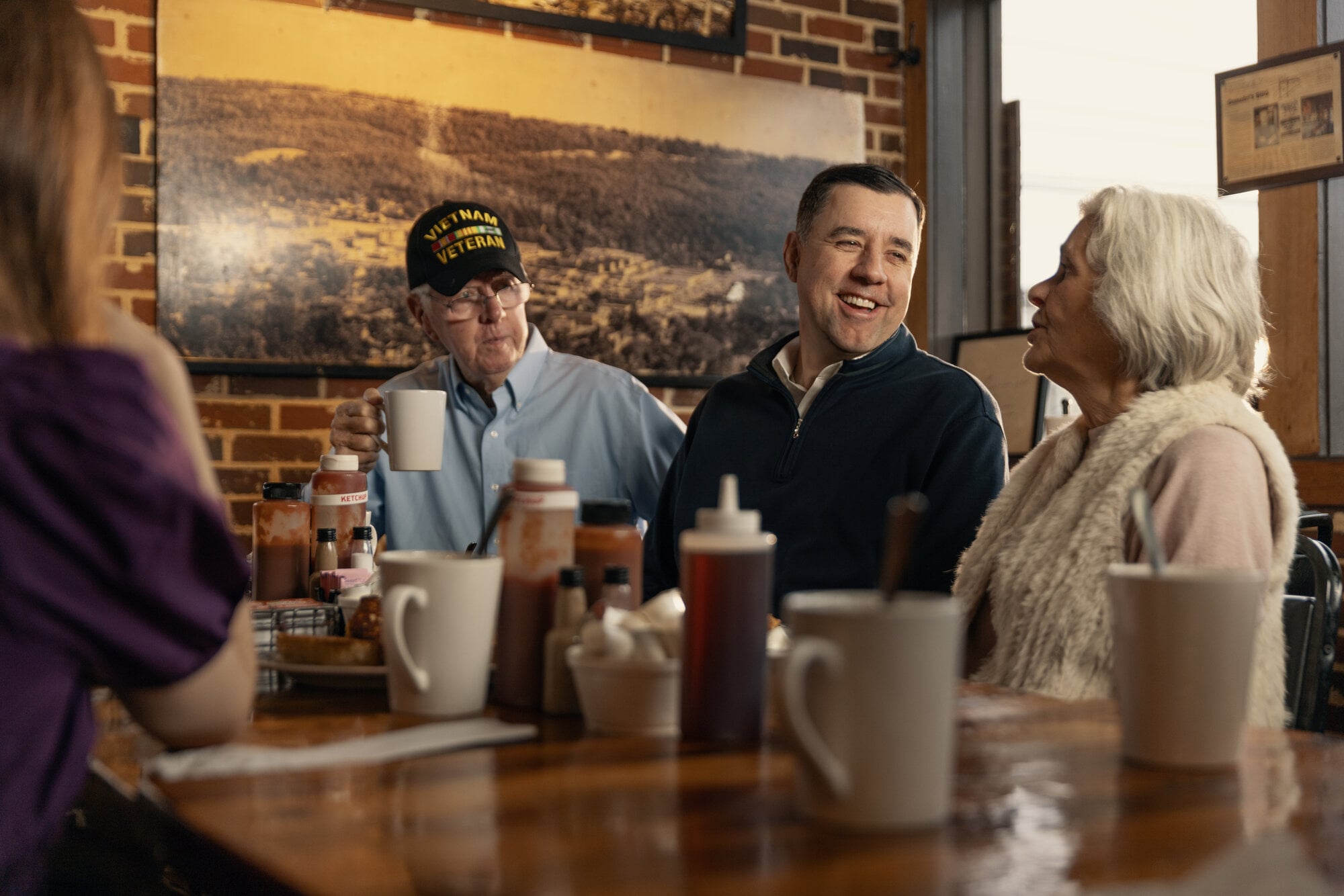 Jay Mitchell talking with constituents at a local diner